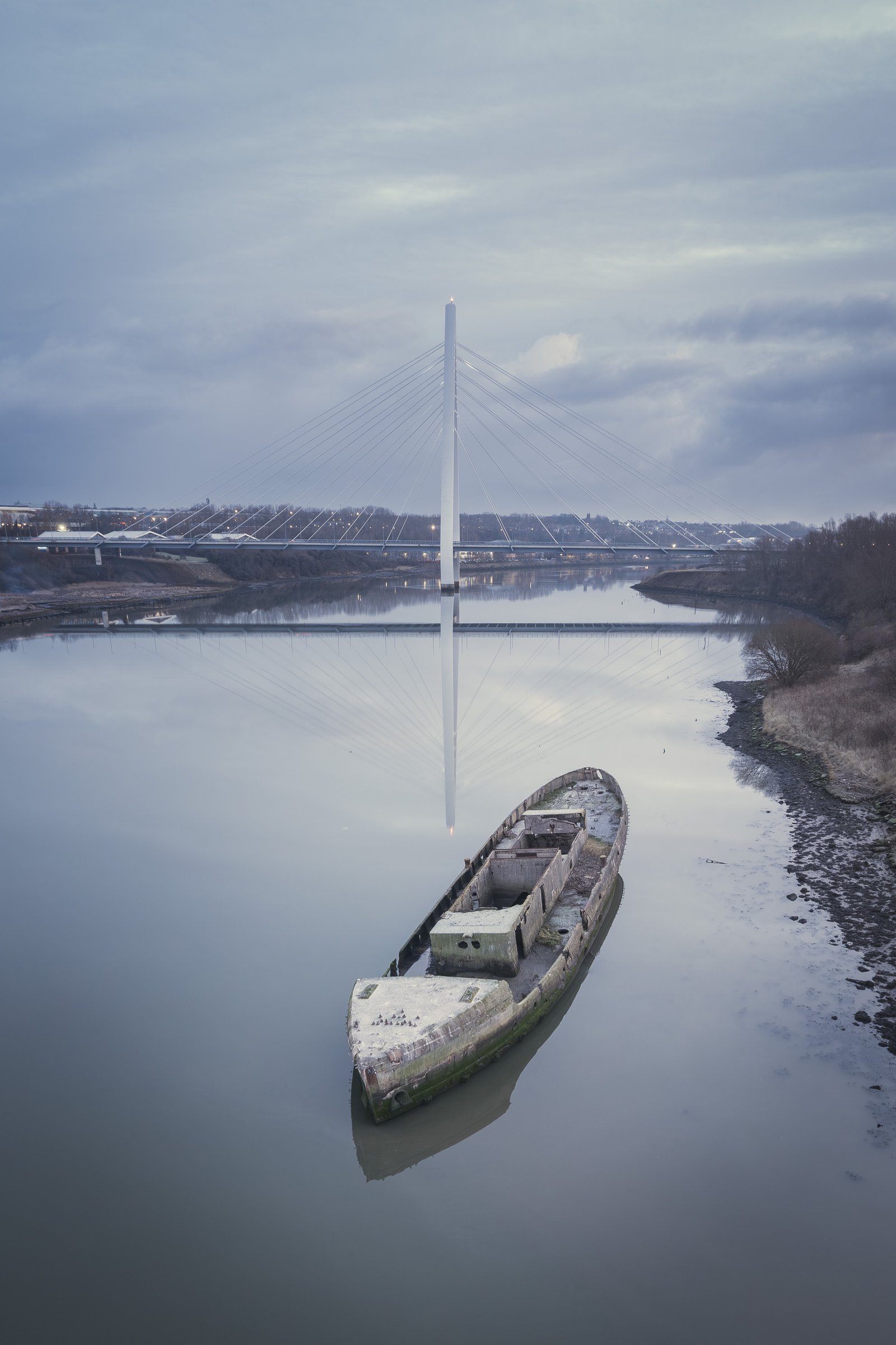 Aerial view of the Northern Spire Bridge with a shipwreck visible nearby